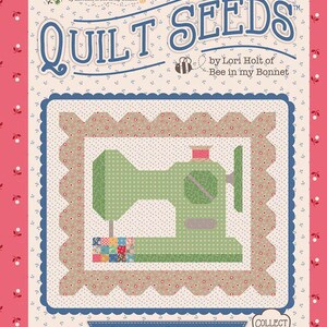May include: A rectangular pattern card titled Quilt Seeds by Lori Holt of Bee in my Bonnet. The card features a central illustration of a green sewing machine on a floral background, surrounded by a scalloped border and pink floral edges.