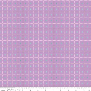 May include: A lavender fabric with a grid pattern. Each square of the grid has a small, light blue floral design in the center. The grid lines are made of a dotted, light pink color. The fabric is marked with inches.