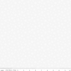 May include: White fabric featuring a repeating pattern of small snowflake designs. The snowflakes are scattered across the surface. The fabric has a solid white background, suitable for winter or festive projects.