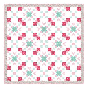 May include: A square quilt featuring a repeating geometric pattern of white, light pink, dark pink, and mint green fabric blocks. The design includes floral-patterned squares and a thin floral border framing the entire piece on all four sides.