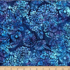 May include: A patterned fabric featuring a floral design in shades of blue and purple. The pattern includes large, stylized flowers and leaves set against a dark blue backdrop. The fabric has a batik-like appearance, with colour and texture variations.