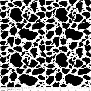 May include: A fabric pattern featuring an irregular black and white cow print design. A white ruler with black markings is visible at the bottom, showing a measurement scale from 0 to 12 inches, with the text Riley Blake Designs printed on it.