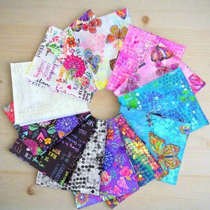 May include: A circular arrangement of patterned fabric squares. Designs include butterflies, flowers, and inspirational quotes. The fabrics are in shades of pink, blue, purple, and black. Each square is approximately 20 cm.