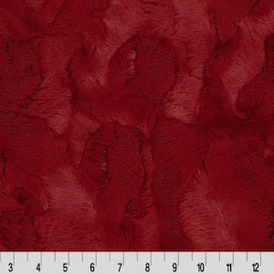 May include: A trio of cream-glazed ceramic mugs with a speckled finish. Each mug is adorned with a hand-painted design: a blue and green leaf, a yellow flower, and a red berry. The mugs have a simple, modern design.