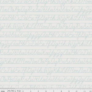 May include: White fabric with a light blue cursive alphabet pattern. The design features rows of handwritten letters on lined paper, with a ruler along the bottom. The fabric is from Riley Blake Designs.