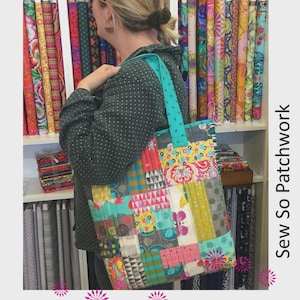 May include: A colorful patchwork tote bag with a teal strap is held by a person. The bag features a variety of fabric patterns and colors, including pink, yellow, and teal. The text "EVERYDAY TOTE" is at the top of the image.