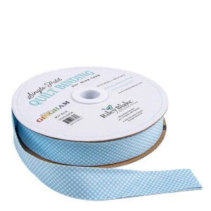 May include: A spool of blue and white gingham quilt binding tape. The label reads "Single-Fold Quilt Binding" and "Boy Blue". The tape is 6.35 cm wide and made of 100% cotton. The brand is Riley Blake Designs.