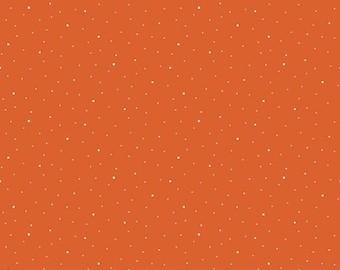 May include: A vibrant orange fabric featuring a scattered pattern of small white dots of varying sizes. A white ruler is visible at the bottom edge, showing a scale of 30.48 cm, with the text Riley Blake Designs printed along the margin.