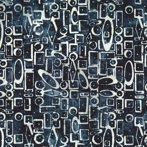 May include: A dark navy blue fabric featuring a repeating pattern of white geometric shapes including circles, rectangles, diamonds, and ovals. The design has a hand-stamped appearance with subtle variations in the white ink and blue background.