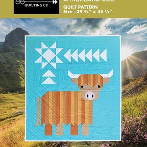 May include: A quilt pattern titled "Cattle Call A Highland Coo" with a turquoise background and a geometric design of a Highland cow. The quilt measures 39 3/4" x 45 1/4". The design includes white star and arrow shapes.