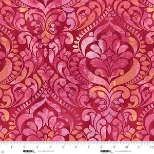 May include: A fabric featuring a repeating damask pattern in shades of deep red, magenta, and soft orange. The design has a distressed, textured appearance with layered colors. A white ruler measuring up to 12 inches is visible at the bottom edge.