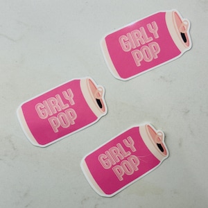 May include: Three pink and white stickers shaped like soda cans with the text "Girly Pop" on each.