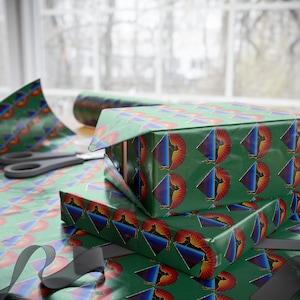 May include: A stack of green gift boxes with a repeating pattern of a black and red graphic. The boxes are wrapped in paper with a repeating pattern of a black and red graphic.