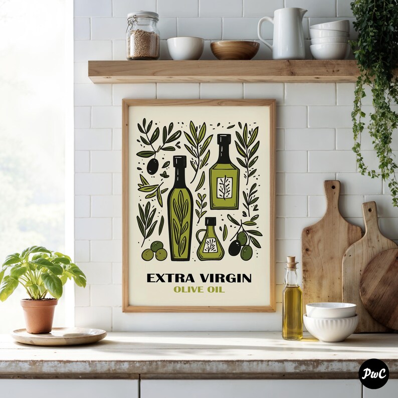 May include: A framed print with a white background and a green and black illustration of olive oil bottles, olive branches, and olives. The text "EXTRA VIRGIN OLIVE OIL" is printed below the illustration.
