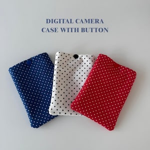 May include: Three digital camera cases with button closures. The cases are in navy blue, white, and red, each with a polka dot pattern. The text "DIGITAL CAMERA CASE WITH BUTTON" is at the top.