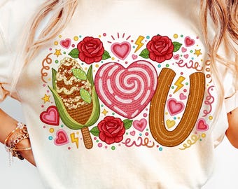 May include: Cream-colored graphic tee with a colorful design. The design includes a corn on the cob, a heart-shaped candy, and a churro, with the letters "YOU" formed by the food items. Red roses, hearts, and lightning bolts complete the design.