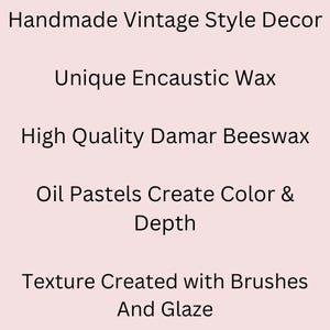 May include: Text on a light pink background reads: Handmade Vintage Style Decor, Unique Encaustic Wax, High Quality Damar Beeswax, Oil Pastels Create Color & Depth, Texture Created with Brushes And Glaze.