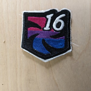 May include: A black and white embroidered patch with a bisexual pride flag design and the number "16" in white.