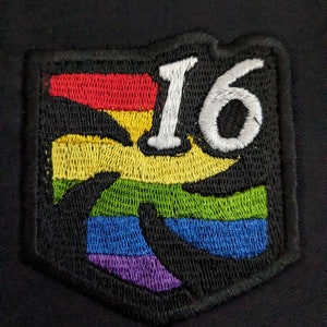 May include: A rainbow-colored embroidered patch with the number 16 in white lettering.