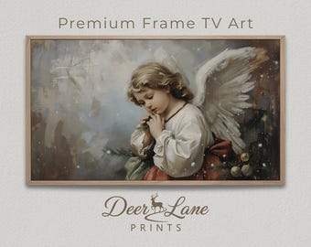 May include: A framed print featuring a vintage-style painting of a young angel with blonde hair, white wings, and a white robe with a red sash. The text "Premium Frame TV Art" is at the top, and "Deer Lane Prints" is at the bottom.