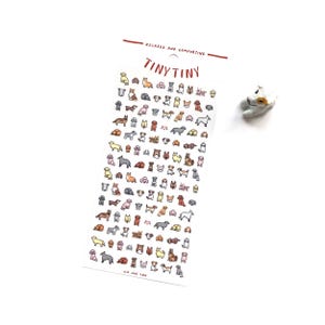 May include: A sheet of stickers featuring various dog breeds in a cartoon style. The stickers are in different colors and poses. The text "TINY TINY" is at the top, with the words "RELAXED AND COMFORTING" above it. A small dog figurine is to the right.