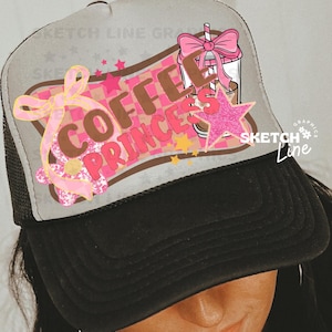 Peut inclure: Un chapeau de camionneur gris et noir avec un motif rose et marron qui dit "Coffee Princess" et représente un gobelet à café dessin animé avec un nœud rose. Le chapeau a un dos en maille.