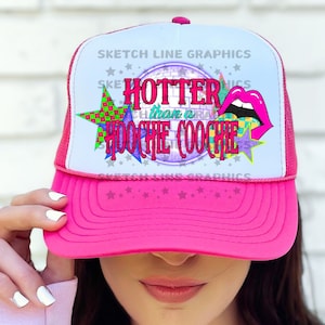 May include: Pink trucker hat with a white mesh back. The front of the hat features a colorful graphic with the text "Hotter than a  Hoochie Coochie".