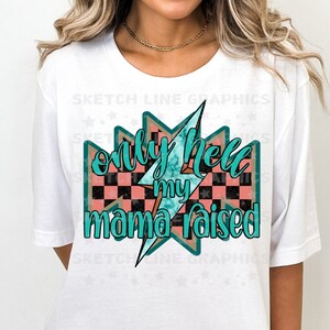 May include: White t-shirt with a graphic design of a teal lightning bolt and checkered pattern. The text on the graphic reads "only hell my mama raised".