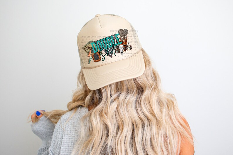 May include: A beige trucker hat with a turquoise and brown graphic that says "Double Shot" and features a heart, playing cards, and other designs.