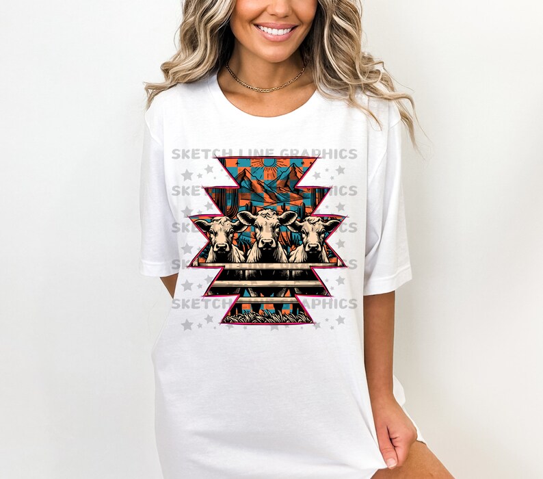 May include: White t-shirt with a graphic design of three cows in front of a fence with a southwestern pattern. The design includes mountains, a sun, and cacti. The text "Sketch Line Graphics" is repeated around the design.