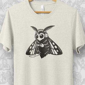 Gamer Mothman or Mothboy with Headphones and Playing a Video Game T-shirt. 7 Color Versions, Funny Unisex Gift Tee for a Man or Woman.