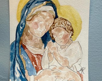 May include: A watercolor painting on paper depicting a figure in a blue head covering and red garment holding a small child in white clothing. Both figures have yellow halos behind their heads. The style uses soft washes and visible brushstrokes.
