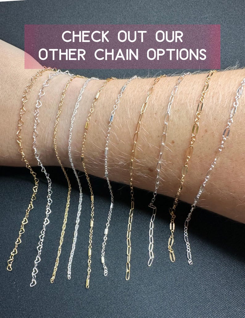 May include: A variety of gold, silver, and mixed metal chains are displayed on a person's wrist. The chains are all different styles, including heart, box, and cable chains. The text "CHECK OUT OUR OTHER CHAIN OPTIONS" is displayed above the chains.