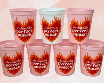 May include: Set of seven pink and white plastic cups with a flame design and the text "she found her perfect match" or "I found my perfect match".
