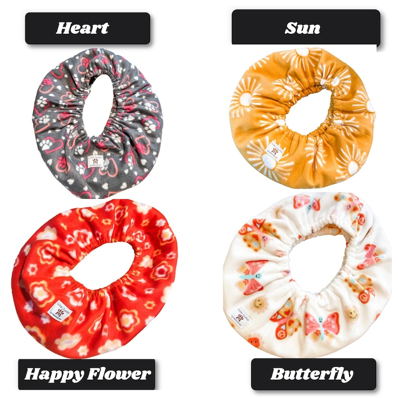 May include: Four circular fabric bowl covers with elastic edges. Top left: gray with pink hearts and white paw prints labeled Heart. Top right: mustard yellow with white suns labeled Sun. Bottom left: red with white flowers labeled Happy Flower. Bottom right: white with colorful butterflies labeled Butterfly.