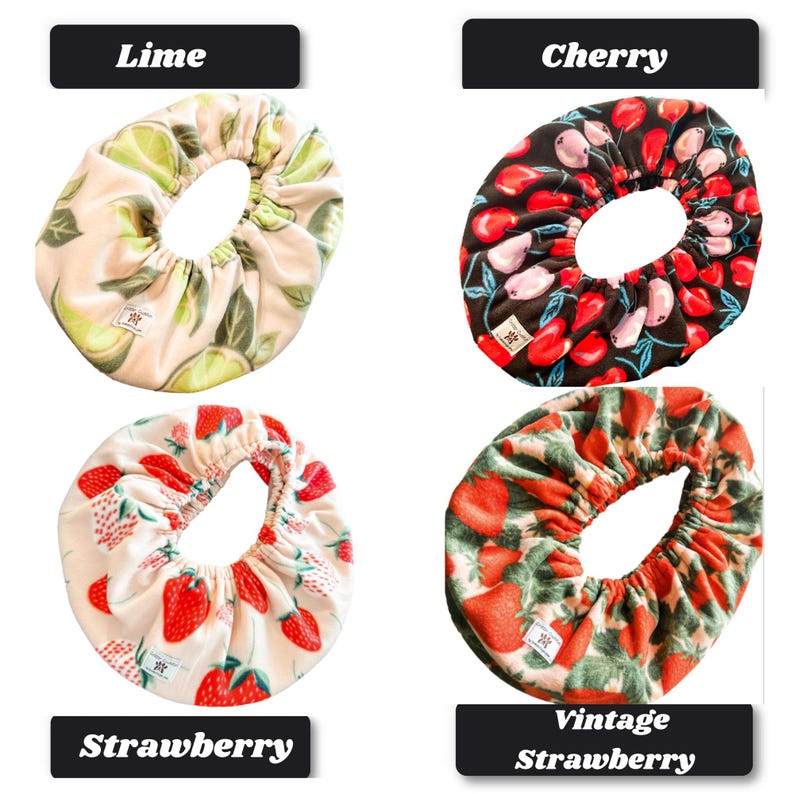 May include: Four circular fabric bowl covers with elastic edges. The top left features a lime pattern on a cream background. The top right shows a cherry print on black. The bottom left displays strawberries on cream, and the bottom right has a vintage strawberry pattern on green.