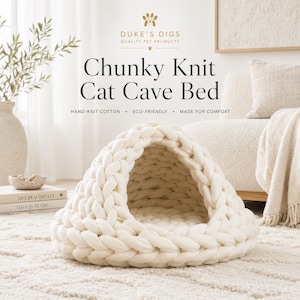 May include: A cream-colored chunky knit cat cave bed with a rounded dome shape and a wide front opening. The text DUKE'S DIGS QUALITY PET PRODUCTS, Chunky Knit Cat Cave Bed, HAND-KNIT COTTON, ECO-FRIENDLY, and MADE FOR COMFORT is visible above the bed.