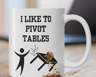 May include: White ceramic coffee mug with a black graphic of a person flipping a table with the text "I like to pivot tables".