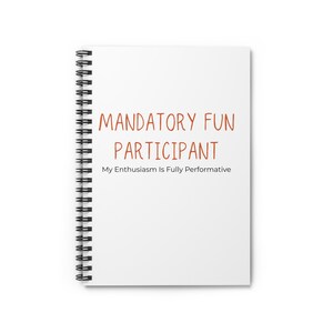 May include: White spiral-bound notebook with the words "MANDATORY FUN PARTICIPANT" in orange-brown letters. Below the title, the text reads "My Enthusiasm Is Fully Performative". The notebook is blank inside.
