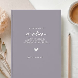 May include: A lavender journal with the text "LETTERS TO MY sister ALWAYS LOVED, NEVER FORGOTTEN, FOREVER IN MY HEART from sienna" in white lettering.
