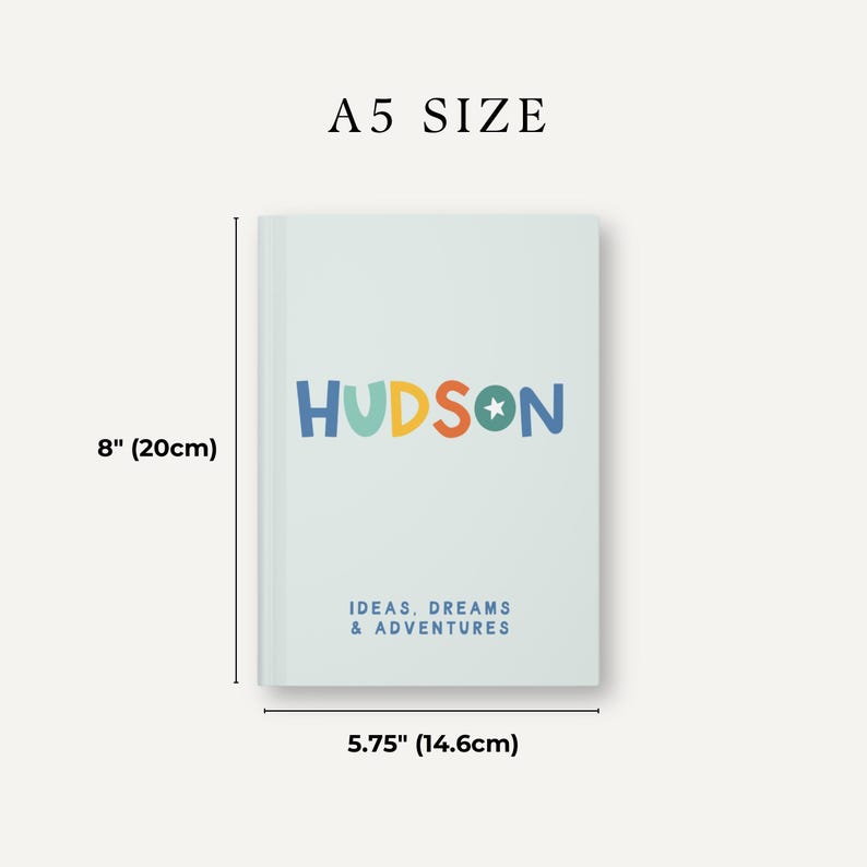 May include: A light blue notebook with the name "HUDSON" in colorful letters and the text "IDEAS, DREAMS & ADVENTURES" in blue. The notebook measures 8 inches by 5.75 inches.