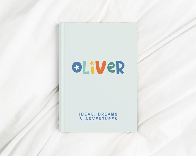 May include: A light blue notebook with the name "Oliver" in colorful letters and the text "Ideas, Dreams & Adventures".