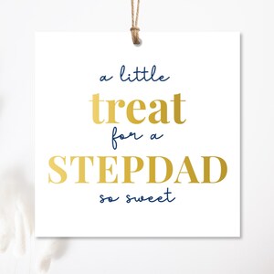 May include: White square gift tag with the text "a little treat for a STEPDAD so sweet" in gold and navy blue lettering. The tag is suspended by a brown string.