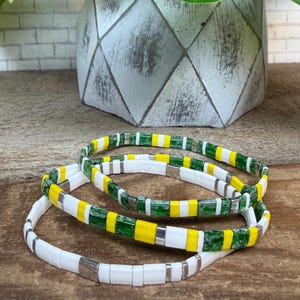 Tila spirit bracelets!  Stack or single. Color: green Picasso, yellow, white, silver