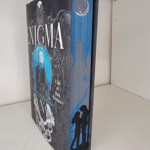 Enigma by Runyx with sprayed edges book, stenciled edges, painted book edges, special edition book, book merch, custom book