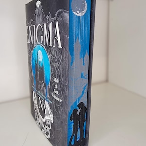 Enigma by Runyx with sprayed edges book, stenciled edges, painted book edges, special edition book, book merch, custom book