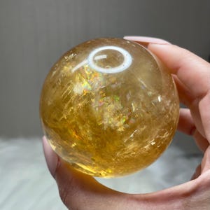 Beautiful rainbow honey calcite sphere