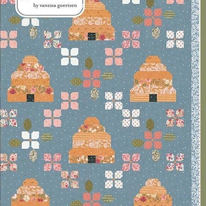 May include: A quilt pattern featuring a repeating design of stylized beehives in shades of orange and floral patterns, set against a blue background with white polka dots. The quilt has a floral border and the text "Lella Boutique" and "Bloom & Buzz".