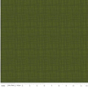 May include: A green fabric with a subtle woven pattern. The fabric has a slightly textured surface and a dark green color.