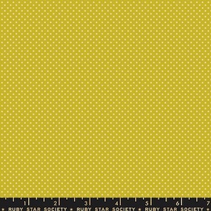 May include: Mustard yellow fabric with a repeating pattern of small white polka dots. The fabric has a smooth texture and is suitable for various sewing projects. The bottom of the image has text that reads "RUBY STAR SOCIETY".